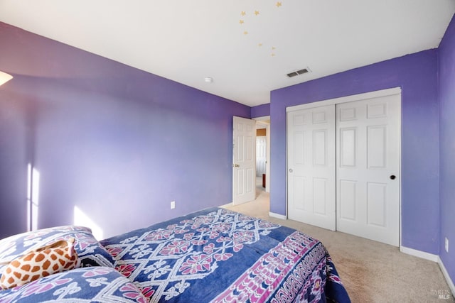 bedroom featuring carpet floors, a closet, visible vents, and baseboards