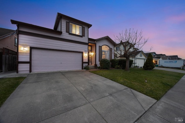 traditional-style house with a garage, a lawn, and driveway