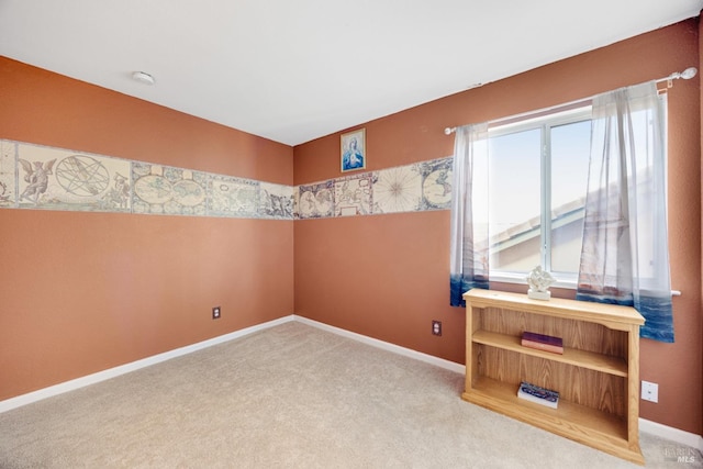 empty room with carpet floors and baseboards