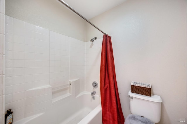 bathroom featuring shower / bath combination with curtain and toilet