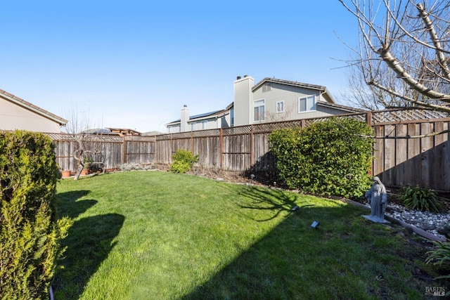 view of yard with a fenced backyard