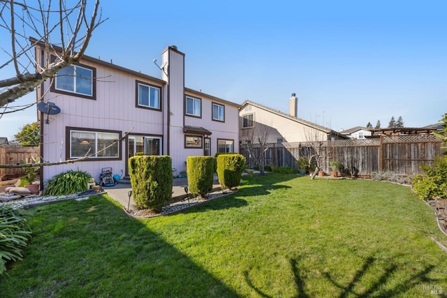 exterior space with a patio, a yard, and a fenced backyard