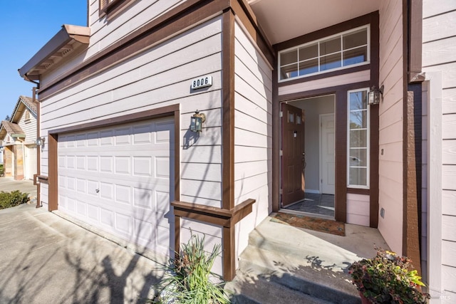 property entrance featuring an attached garage