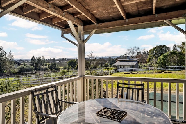 wooden terrace featuring a rural view