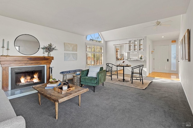 living room with lofted ceiling, carpet, and ceiling fan