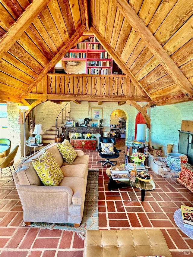 living room featuring wood ceiling, brick wall, and vaulted ceiling with beams