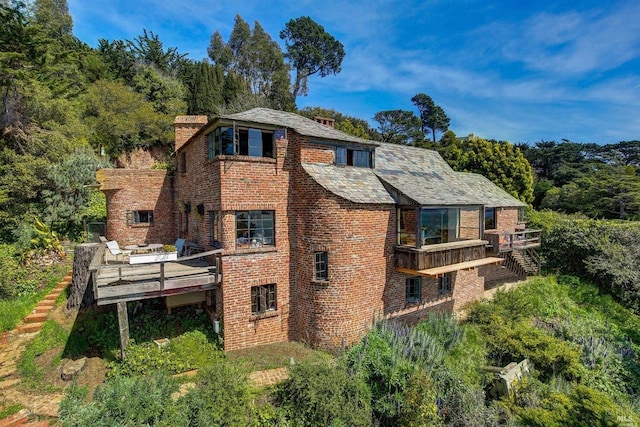 rear view of house featuring a deck