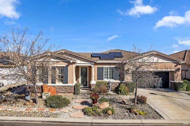 view of front of house featuring a garage and solar panels