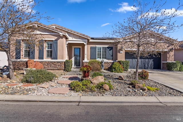 view of front of home featuring a garage and solar panels