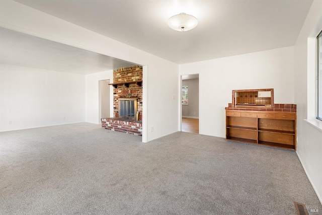 unfurnished living room featuring a fireplace and carpet flooring