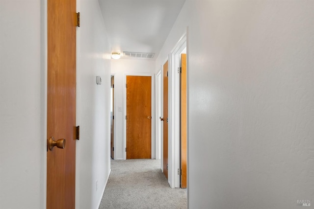 hallway with light colored carpet