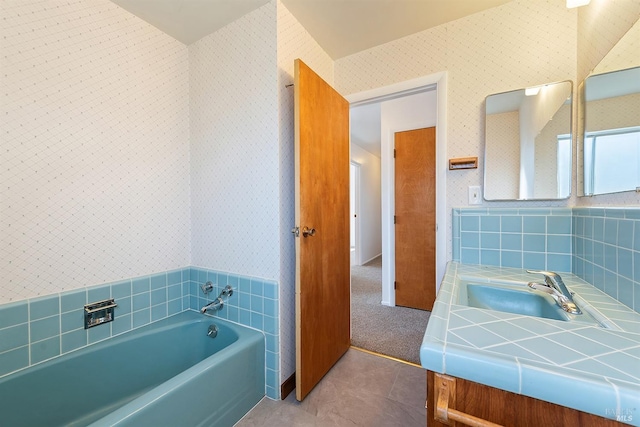 bathroom with vanity, tile patterned flooring, and a bathing tub