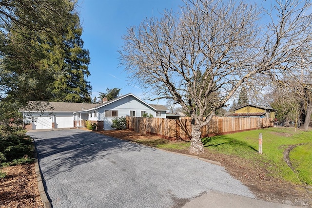 ranch-style home with a garage and a front yard