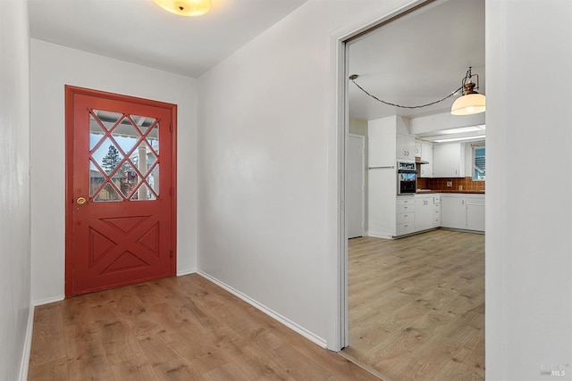 foyer entrance with light hardwood / wood-style floors