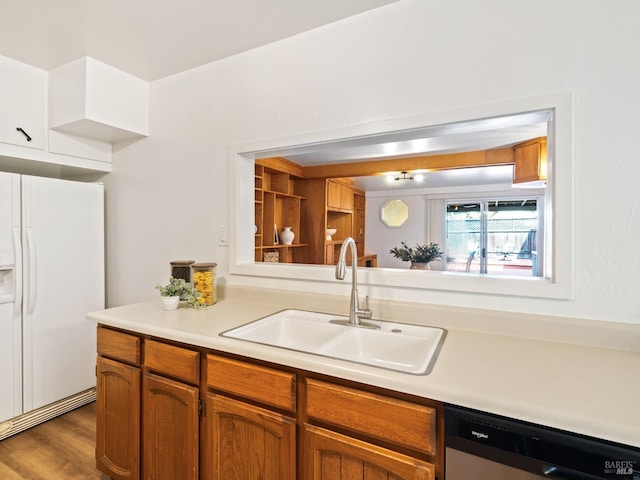 kitchen featuring sink, white fridge with ice dispenser, stainless steel dishwasher, and dark wood-type flooring