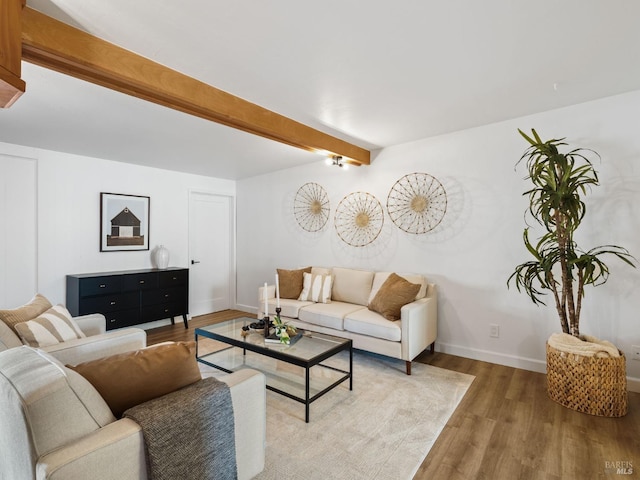 living room with beamed ceiling and hardwood / wood-style floors