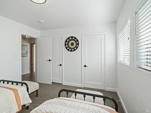 bedroom featuring dark colored carpet