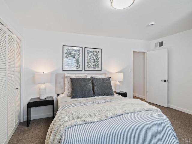 bedroom with dark carpet and a closet