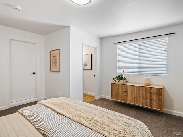 bedroom with dark colored carpet