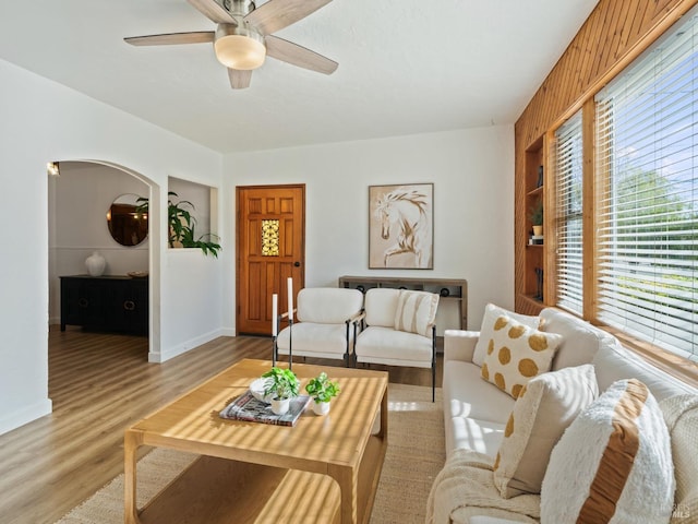 living room with ceiling fan and light wood-type flooring