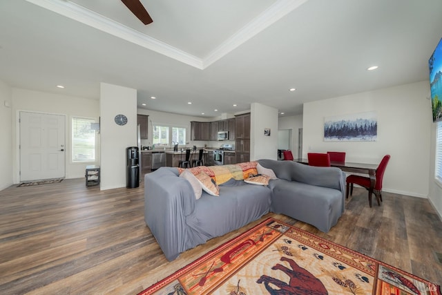 living room featuring dark hardwood / wood-style flooring and ornamental molding