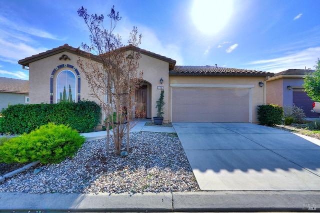 mediterranean / spanish-style house with a garage