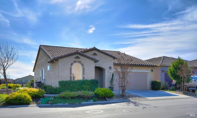 mediterranean / spanish-style house with a garage