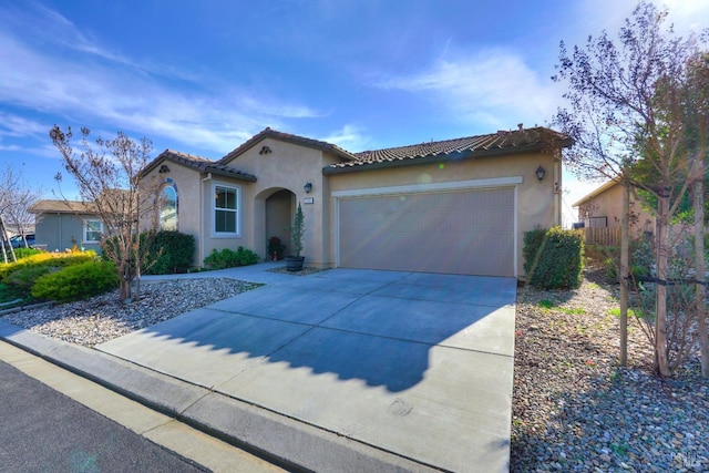 mediterranean / spanish home with a garage