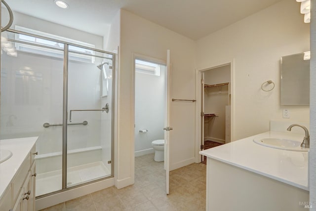 bathroom with vanity, tile patterned flooring, a shower with door, and toilet