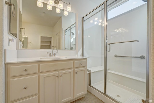 bathroom with vanity, tile patterned floors, and a shower with shower door