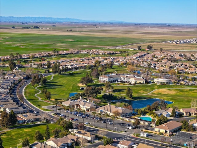 drone / aerial view featuring a water and mountain view