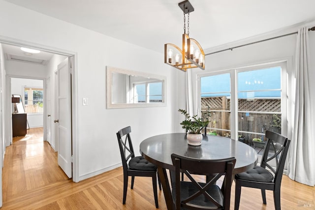 dining area featuring a chandelier and light hardwood / wood-style floors