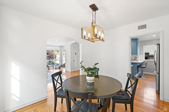 dining room featuring a chandelier and light hardwood / wood-style flooring