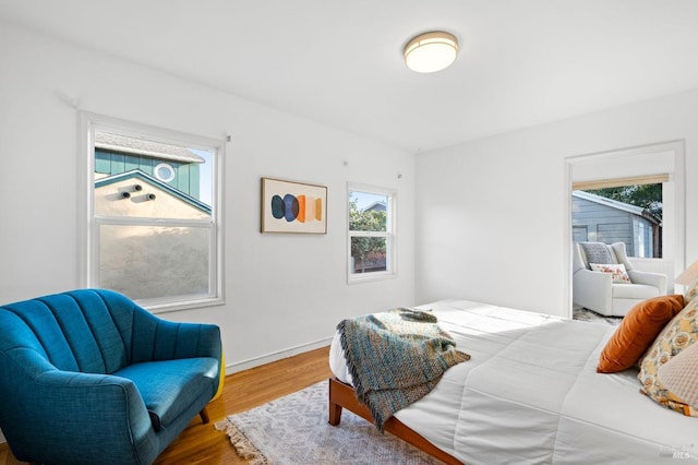 bedroom featuring multiple windows and hardwood / wood-style floors