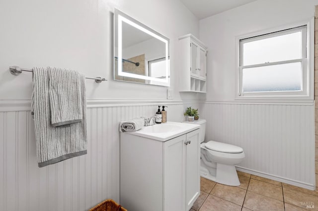 bathroom featuring tile patterned flooring, vanity, and toilet