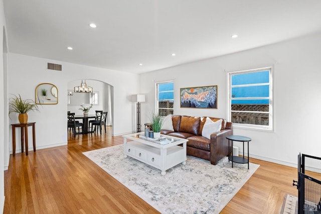 living room featuring a chandelier and light hardwood / wood-style floors