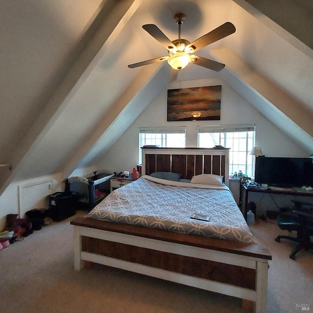 bedroom featuring multiple windows, lofted ceiling, and carpet flooring