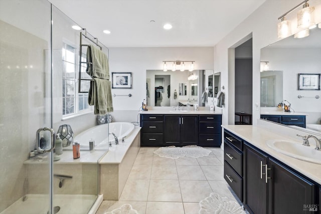 bathroom featuring independent shower and bath, vanity, and tile patterned floors