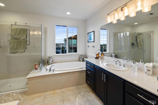 bathroom featuring tile patterned flooring, vanity, and shower with separate bathtub