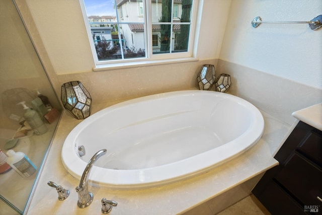 bathroom with vanity and a tub