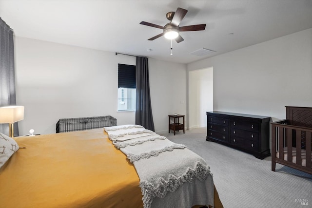 bedroom with ceiling fan and light carpet