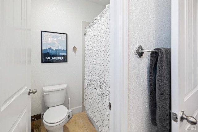 bathroom featuring a shower with shower curtain, toilet, and tile patterned flooring