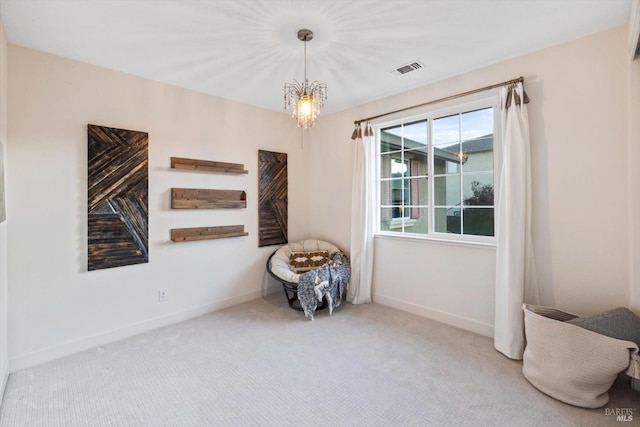 unfurnished room featuring an inviting chandelier and carpet floors