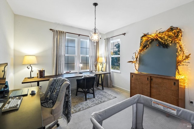 carpeted office space with an inviting chandelier