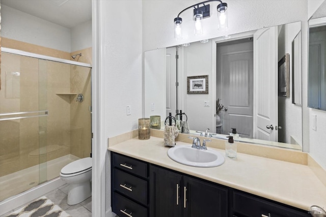 bathroom with vanity, a shower with shower door, and toilet