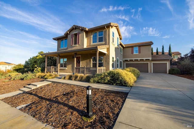 view of front of property with a porch and a garage