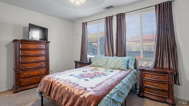 bedroom featuring light colored carpet and ceiling fan