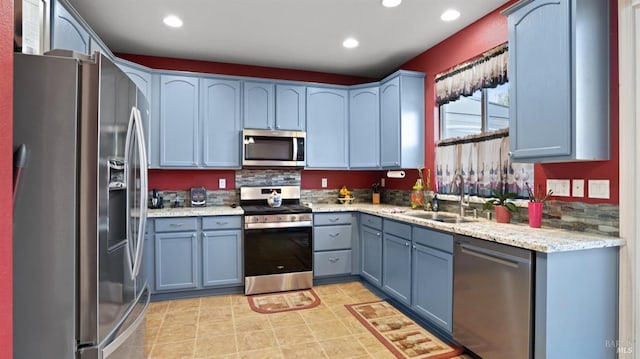 kitchen featuring sink, blue cabinetry, and appliances with stainless steel finishes