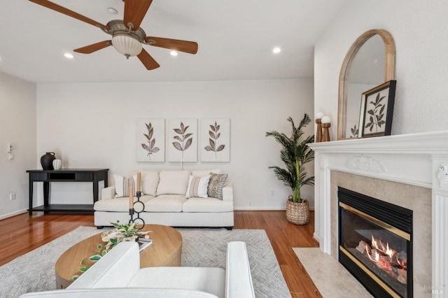 living room with hardwood / wood-style flooring and ceiling fan