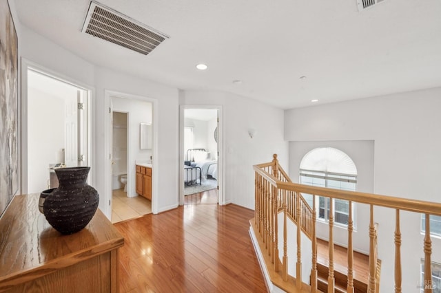 hallway with light hardwood / wood-style flooring